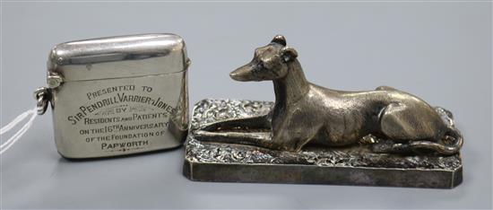 A George V silver vesta case with Papworth related inscription and an Elkington plated model of a recumbent greyhound.